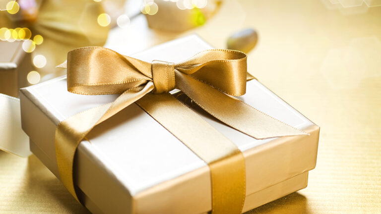 A gift box with golden color ribbon.
