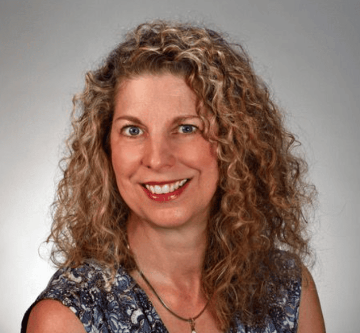 Portrait of Kari Samuels, intuitive counselor and numerologist, smiling confidently.