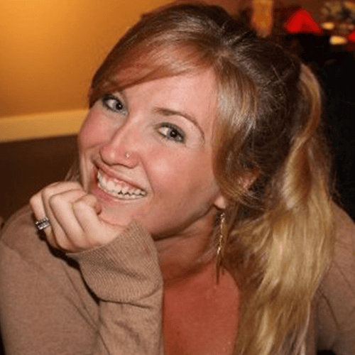 Woman smiling warmly, Kari Samuels, in a cozy setting.